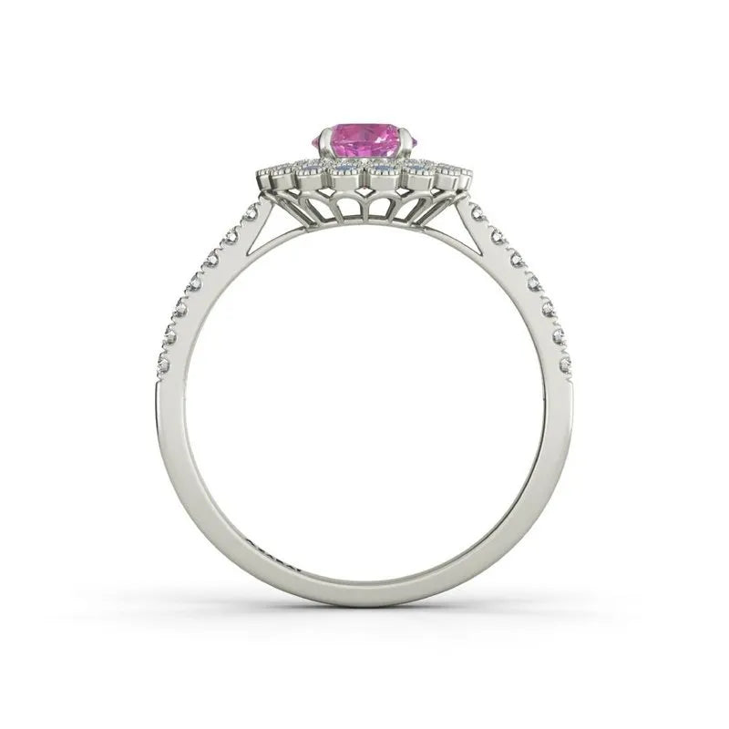 A charming 9kt gold ring with a central pink gemstone and small diamonds embellishing the band is reminiscent of the elegant Portia engagement ring style.