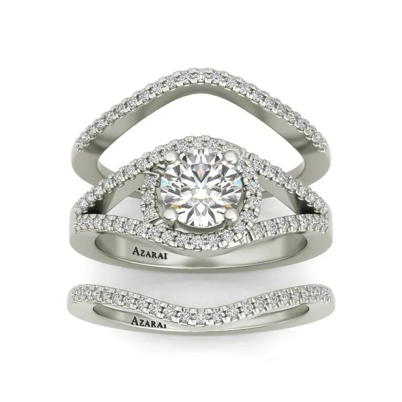 Introducing the Raquel sterling silver bridal set, now part of our exclusive clearance collection. This exquisite three-piece bridal set showcases a central round diamond, beautifully encircled by smaller diamonds on a sterling silver band engraved with "Azarai," offering an unforgettable sparkle.