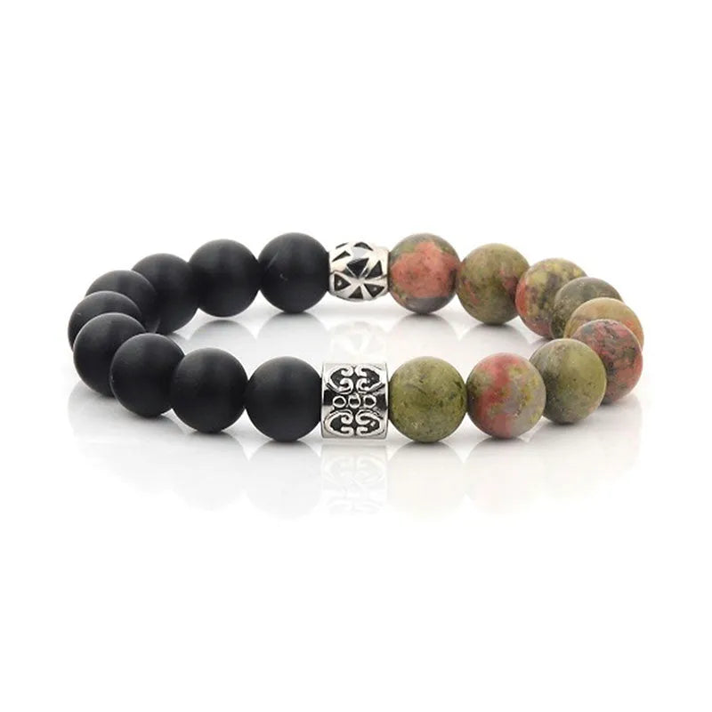 Introducing the Roka beaded bracelet for men, showcasing a stylish combination of half matte black beads and half vibrant multicolored stone beads, complemented by two intricately designed silver spacer beads. It arrives beautifully packaged in an elegant gift box.