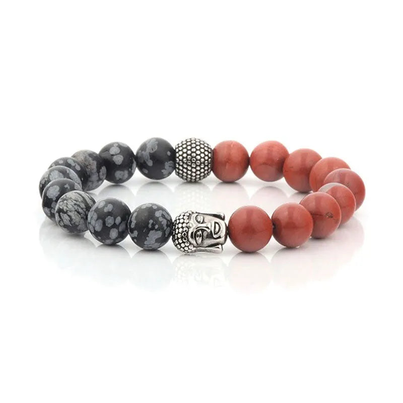 The Roka beaded bracelet for men features semi-precious beads with a red and black speckled design, complemented by a silver Buddha head charm. It comes beautifully packaged in an elegant gift box.