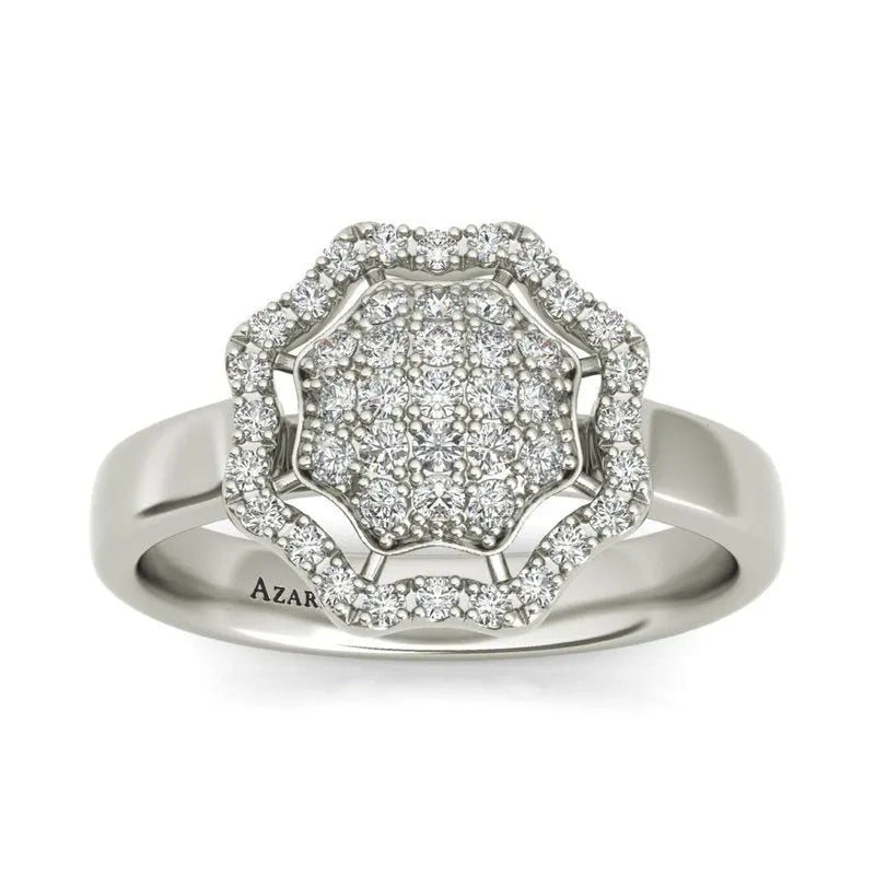 The Rosalyn sterling silver engagement ring, currently on clearance, showcases a round cluster of small diamonds elegantly arranged in a delicate flower-like design.