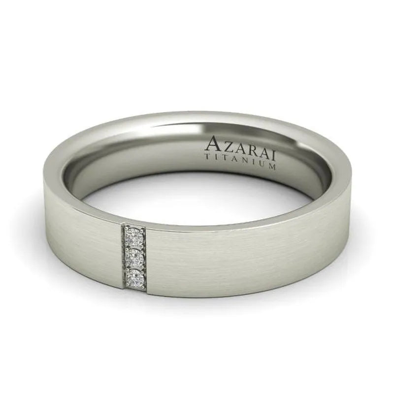 The Rowan titanium wedding band, engraved with "Azarai" and "Titanium" and adorned with three vertically set small diamonds, is now available on clearance in our final sale.