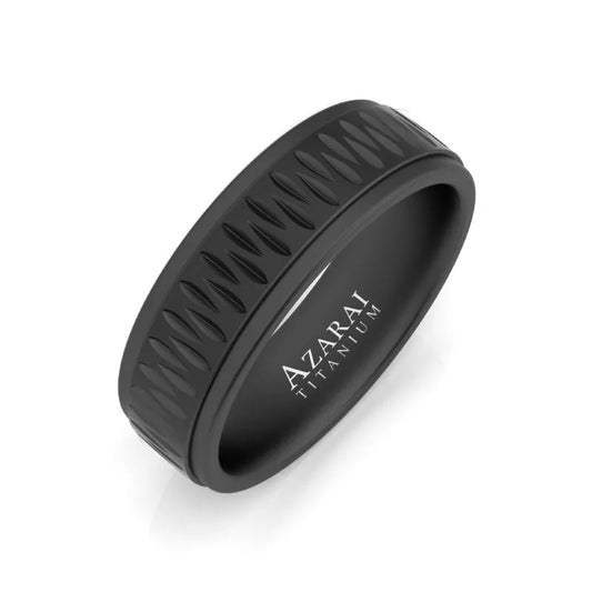 The Sable black titanium wedding band has a textured zigzag pattern encircling its band, with the brand name "Azarai" engraved on the inside.