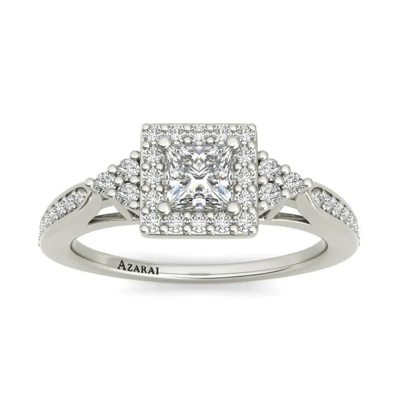 The Selma sterling silver engagement ring showcases a captivating princess-cut diamond, enhanced by pavé diamonds adorning the band, elegantly set in shimmering sterling silver.