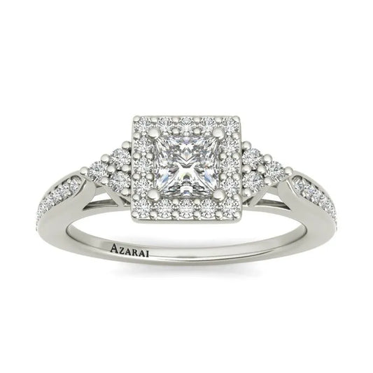 The Selma sterling silver engagement ring showcases a captivating princess-cut diamond, enhanced by pavé diamonds adorning the band, elegantly set in shimmering sterling silver.