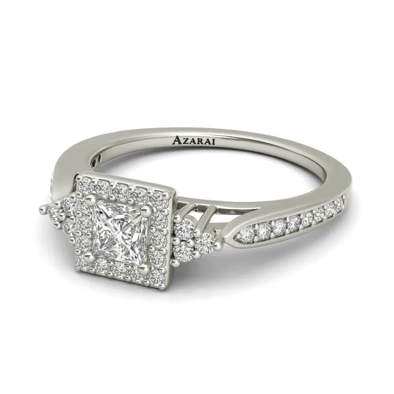 The Selma sterling silver engagement ring features a square diamond centerpiece surrounded by smaller diamonds, with additional diamonds embedded in the band. The inside is engraved with "Azarai.