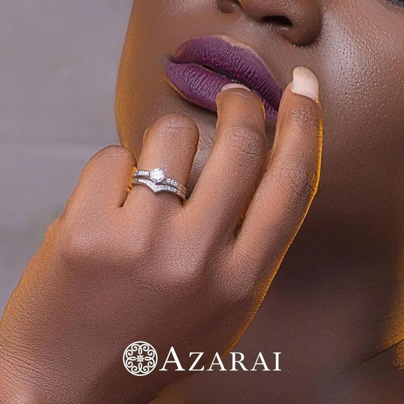 A close-up of a person touching their chin highlights the Sofia sterling silver bridal set on their finger, with the elegant Azarai logo displayed at the bottom.