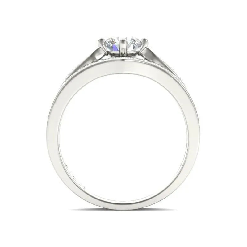 The Sofia sterling silver bridal set showcases a stunning engagement ring with a round-cut diamond in a prong setting, elegantly visible from the side.