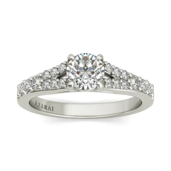 A Sonora sterling silver engagement ring with a central round diamond and smaller diamonds set along the band. The word "AZARAI" is engraved on the side, adding a touch of elegance reminiscent of Sonora's timeless beauty.