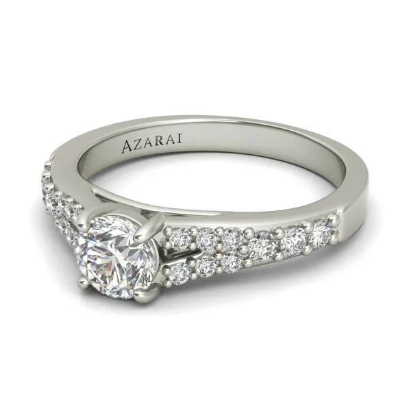 A Sonora sterling silver engagement ring featuring a round-cut diamond centerpiece and smaller diamonds encrusted along the band, with the brand name "AZARAI" engraved on the inside.