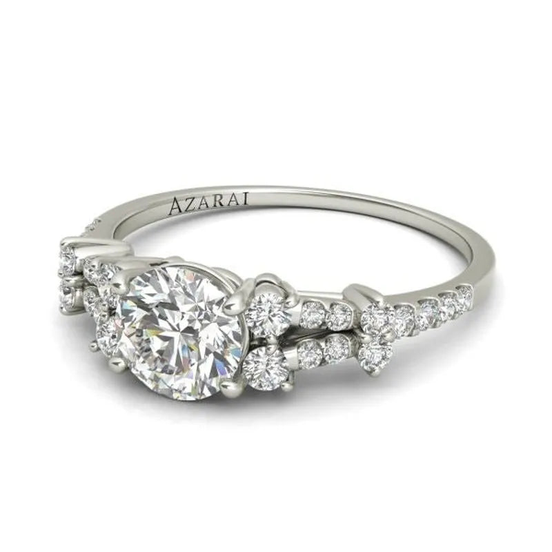 Introducing the elegant Sweetheart 14kt gold engagement ring, featuring a beautifully designed band that showcases a large central diamond, adorned with smaller diamonds and engraved with "AZARAI." This piece embodies timeless elegance and romance.